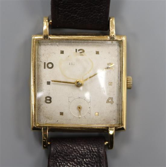 A gentlemans stylish 9ct gold Baume square cased manual wind wrist watch.
